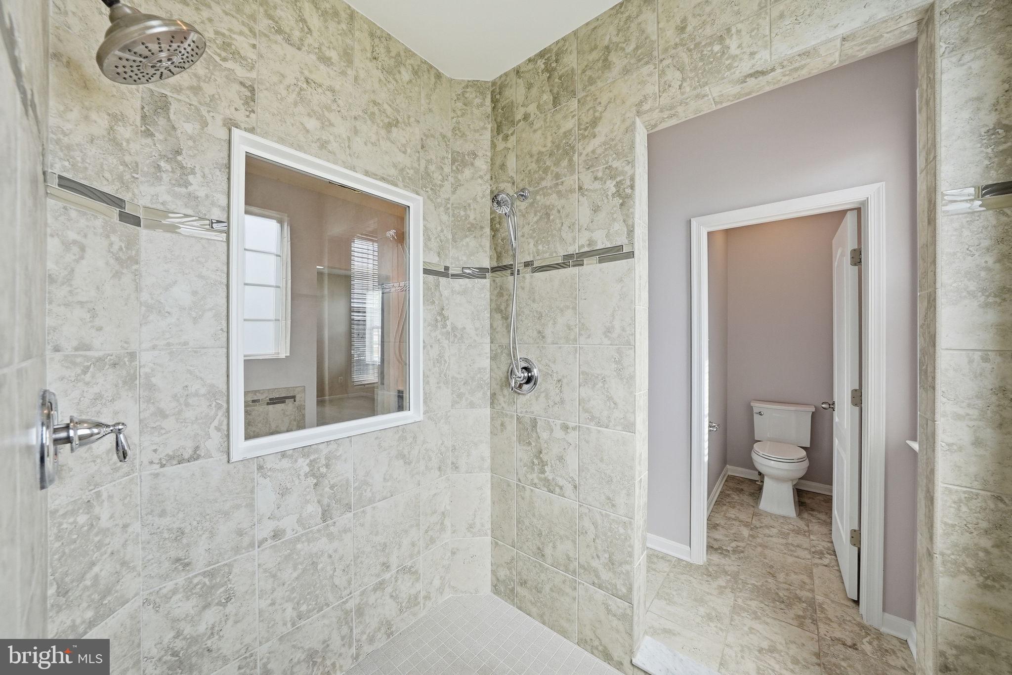 11538 Neon Road Fort Washington, MD 20744 - Photo 33 of 58 a bathroom with a glass shower door