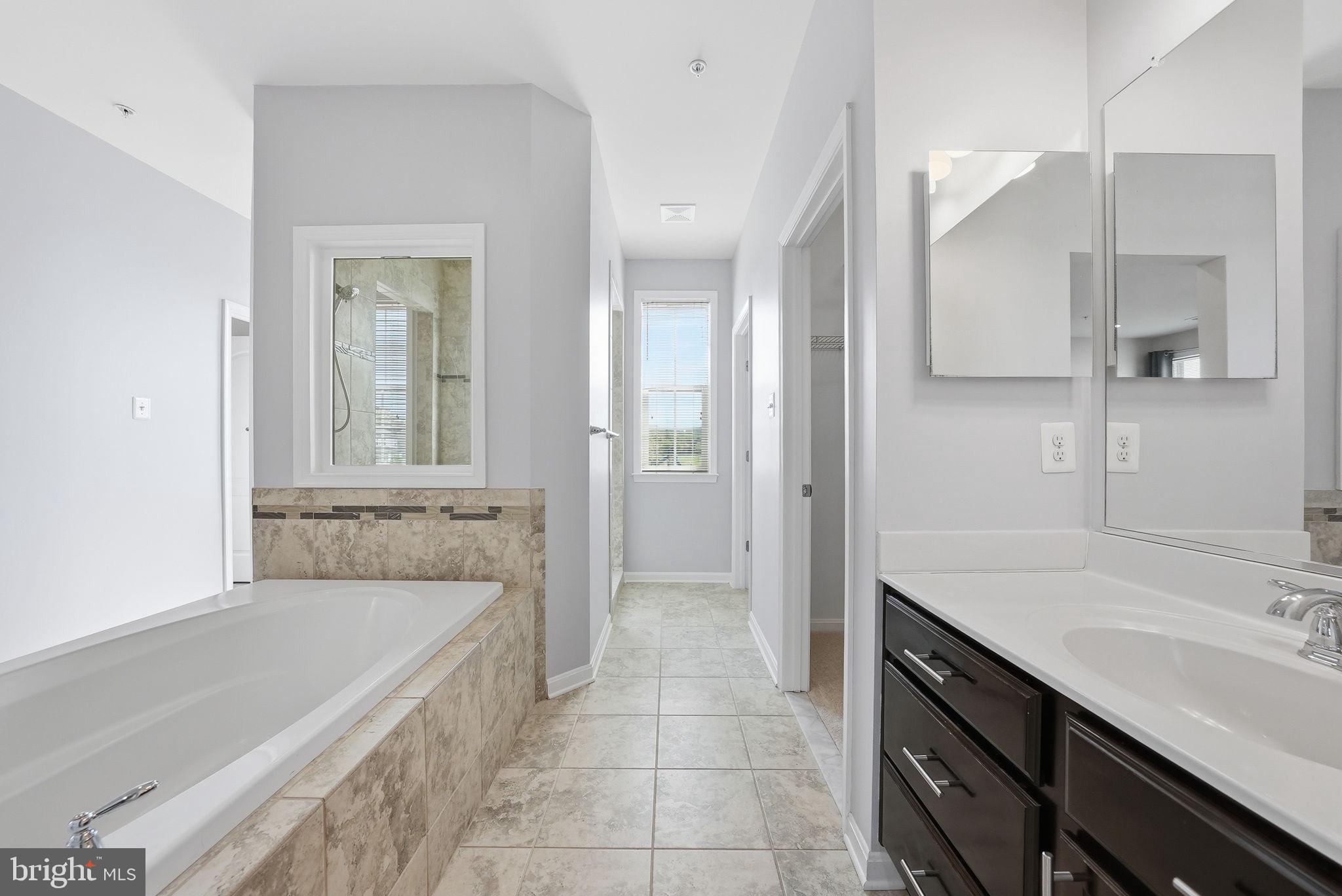 11538 Neon Road Fort Washington, MD 20744 - Photo 36 of 58 a bathroom with a tub sink and mirror