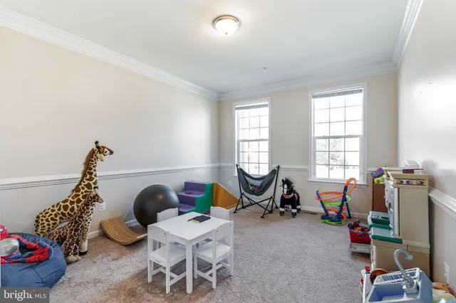 a living room with furniture a flat screen tv and a window