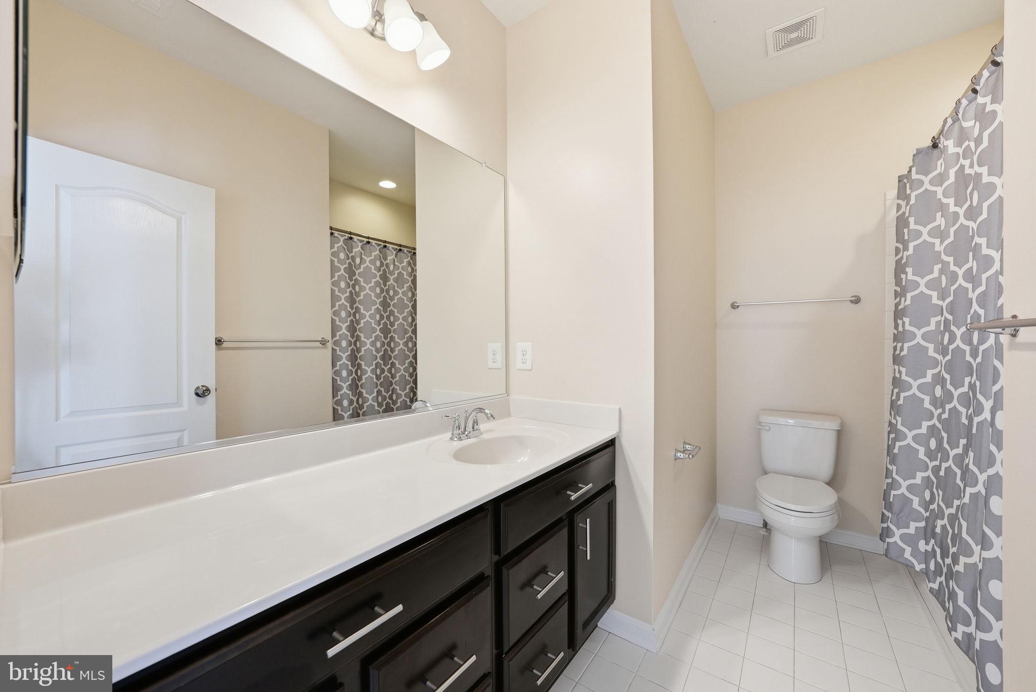 11538 Neon Road Fort Washington, MD 20744 - Photo 45 of 58 a bathroom with a sink a toilet a shower and a mirror