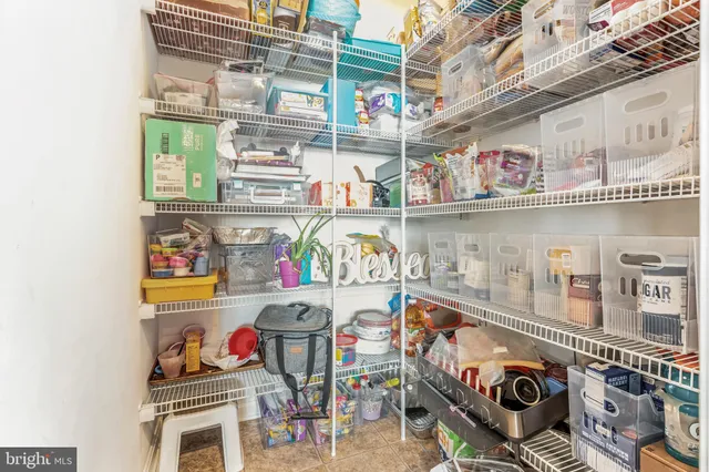 a store room with stainless steel appliances and a table