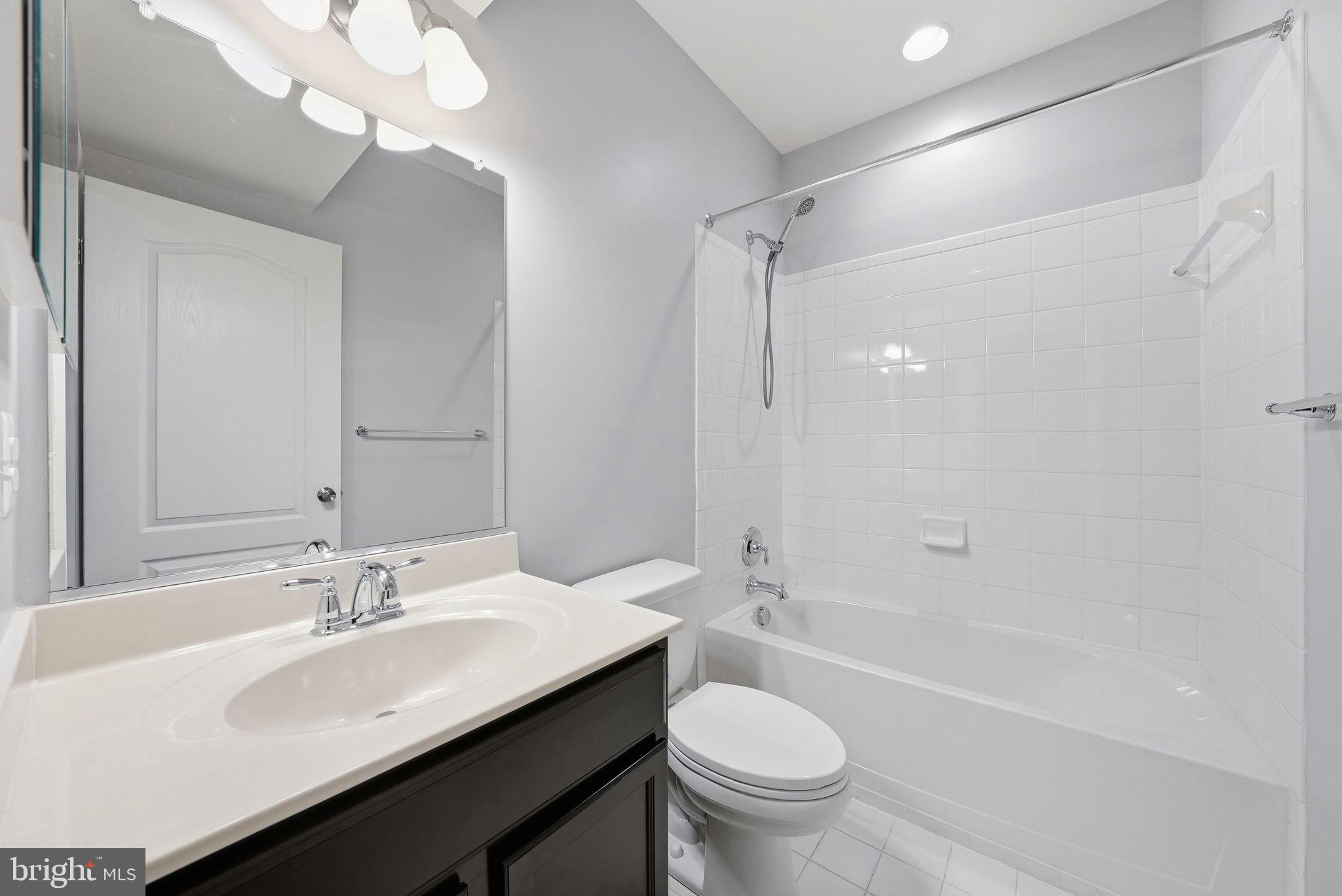 11538 Neon Road Fort Washington, MD 20744 - Photo 51 of 58 a bathroom with a sink a toilet a mirror and shower