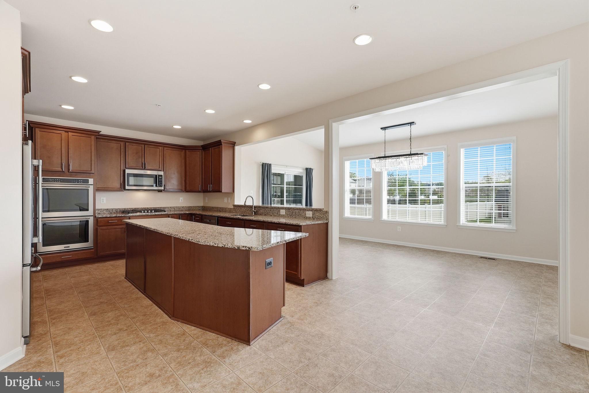 11538 Neon Road Fort Washington, MD 20744 - Photo 6 of 58 a large kitchen with stainless steel appliances granite countertop a large counter top and a stove