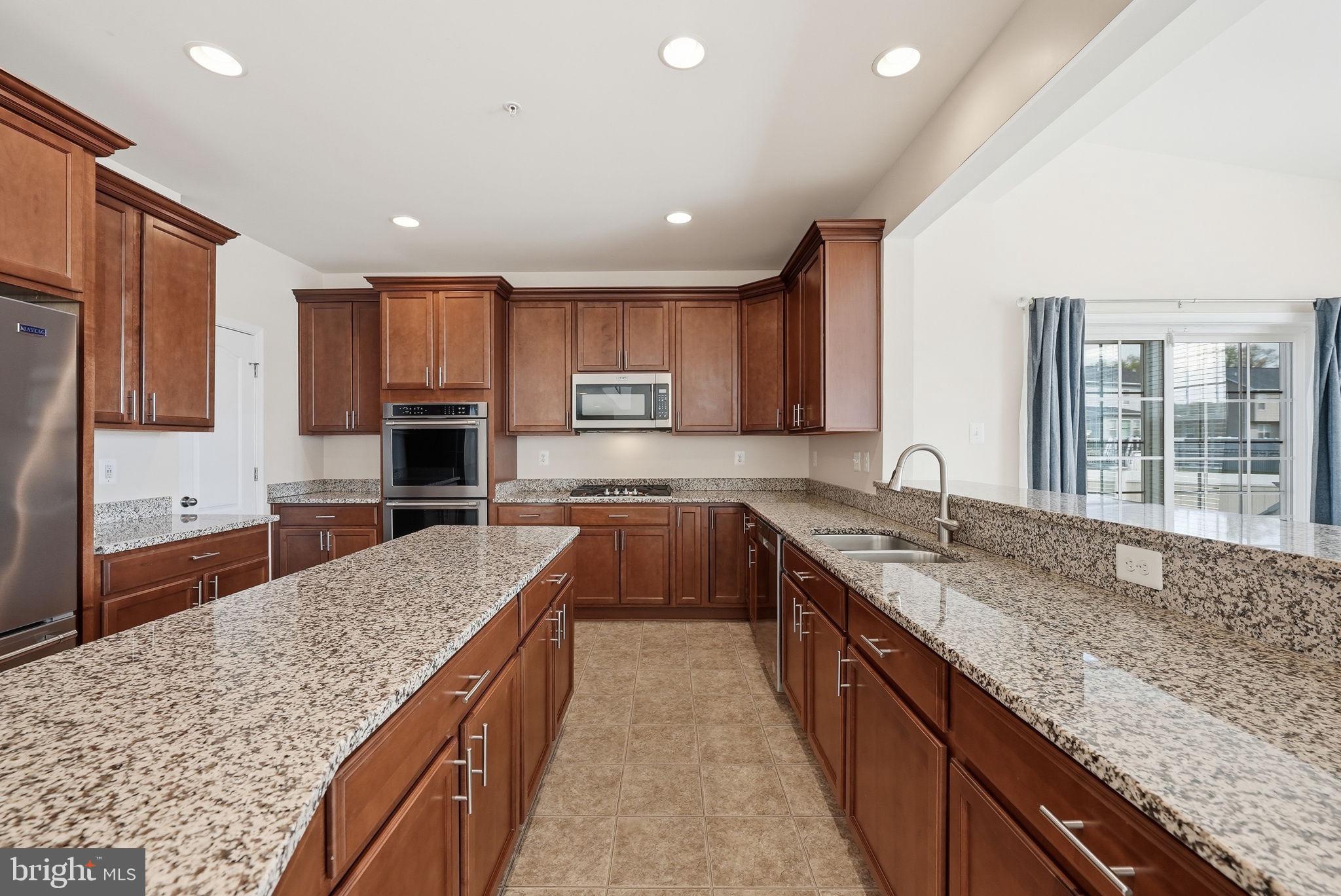 11538 Neon Road Fort Washington, MD 20744 - Photo 8 of 58 a large kitchen with kitchen island granite countertop a large counter top stainless steel appliances and a sink