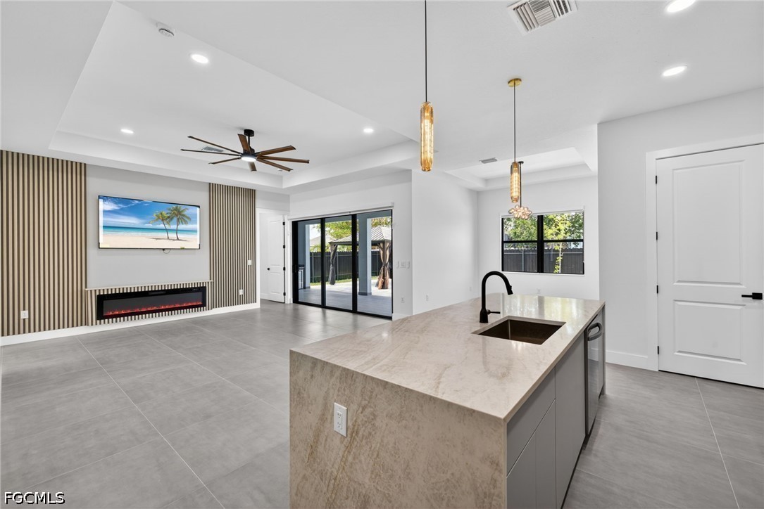 1715 Southwest 4th Street Cape Coral, FL 33991 - Photo 12 of 42 a kitchen with kitchen island stainless steel appliances a sink stove and refrigerator