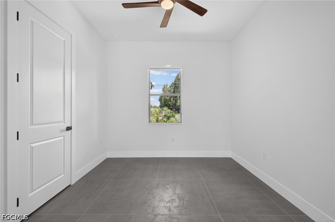 1715 Southwest 4th Street Cape Coral, FL 33991 - Photo 14 of 42 an empty room with a window and a ceiling fan