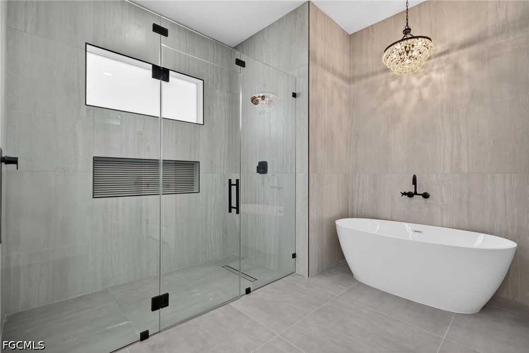 1715 Southwest 4th Street Cape Coral, FL 33991 - Photo 21 of 42 a bathroom with a bathtub and shower