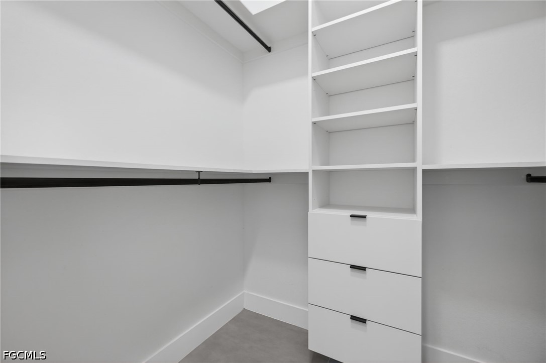 1715 Southwest 4th Street Cape Coral, FL 33991 - Photo 22 of 42 a view of walk in closet with empty racks
