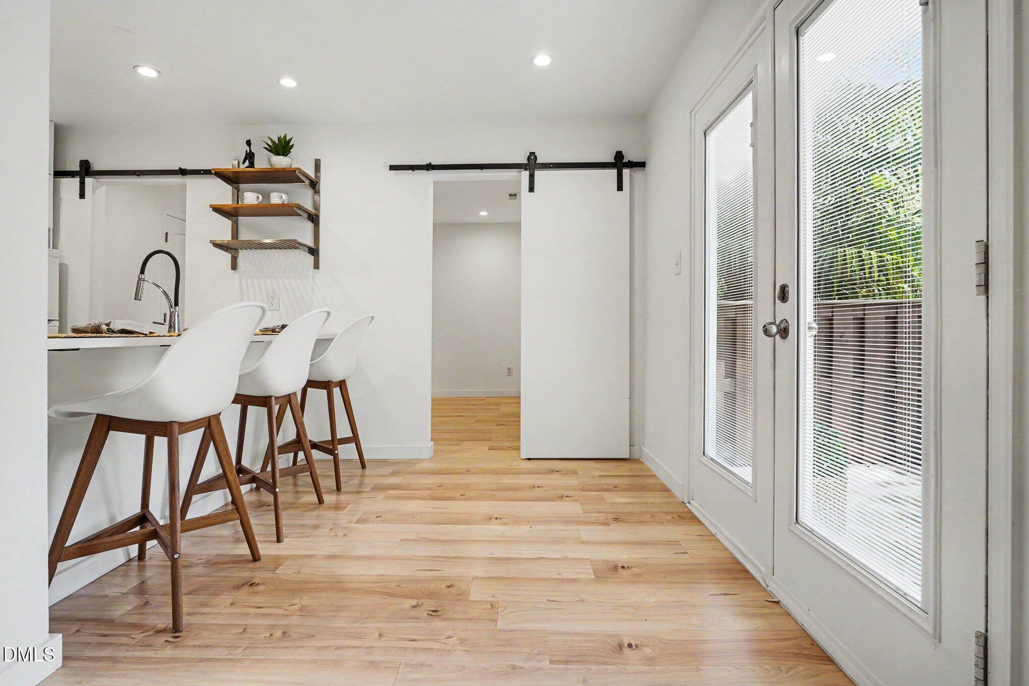 3555 Mill Run Raleigh, NC 27612 - Photo 4 of 25 a view of a dining area with furniture window and wooden floor
