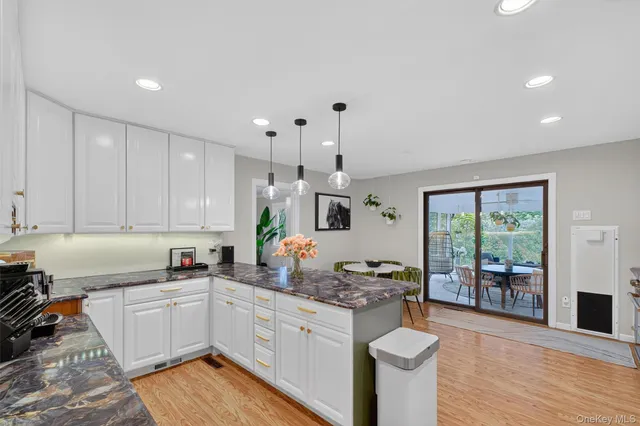 a kitchen with sink a stove and cabinets