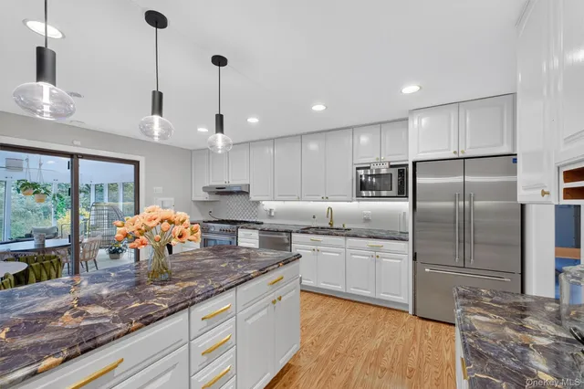 a kitchen with counter top space cabinets and stainless steel appliances