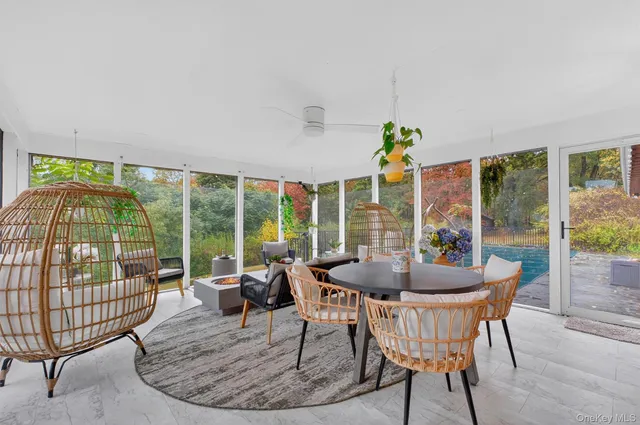 a dining room with furniture a garden and patio