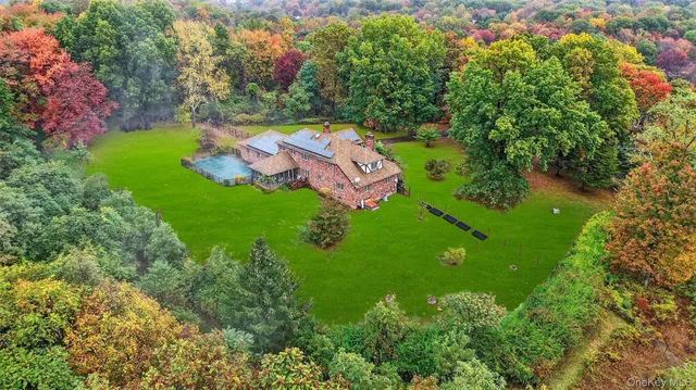 an aerial view of a house with yard