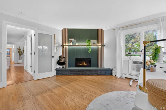 a living room with a fireplace and a flat screen tv