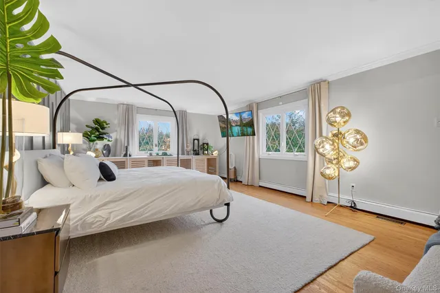 a bedroom with a bed and a painting on the wall