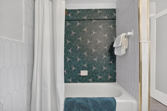 a bathroom with a bathtub and shower