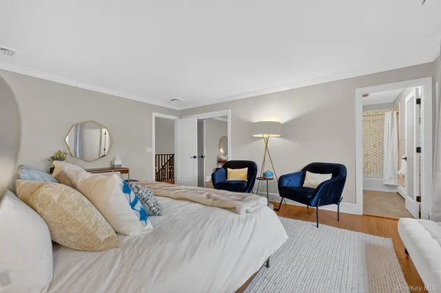 a bedroom with bed and a chair