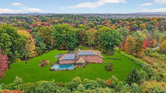 an aerial view of a house with a garden and trees