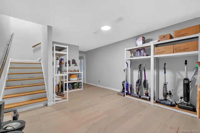 an empty room with stairs and furniture