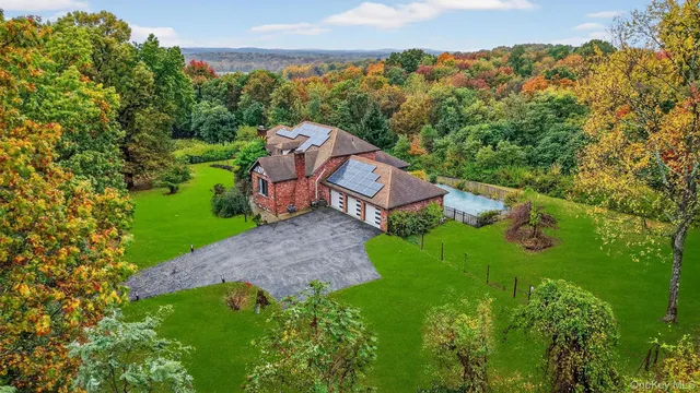 an aerial view of a house with a yard