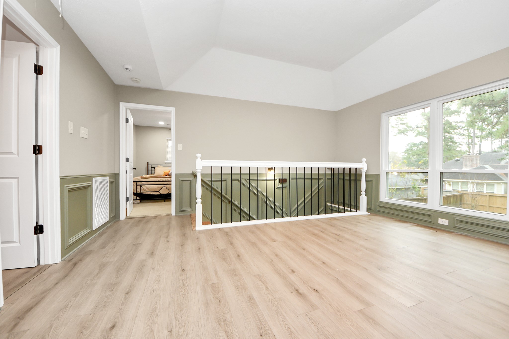 5511 Lacreek Lane Spring, TX 77379 - Photo 30 of 39 a view of a bedroom with wooden floor and balcony