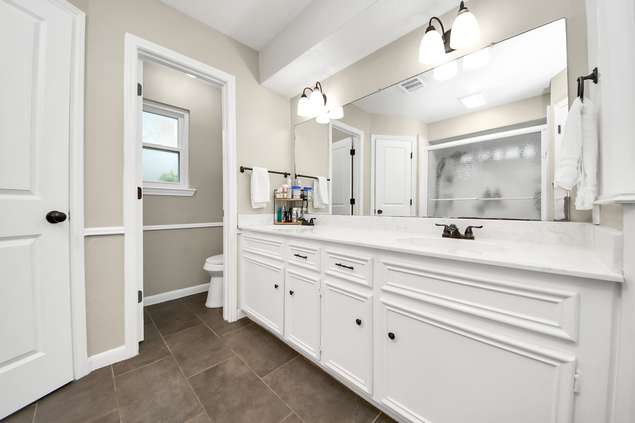 5511 Lacreek Lane Spring, TX 77379 - Photo 33 of 39 a bathroom with a double vanity sink mirror and toilet