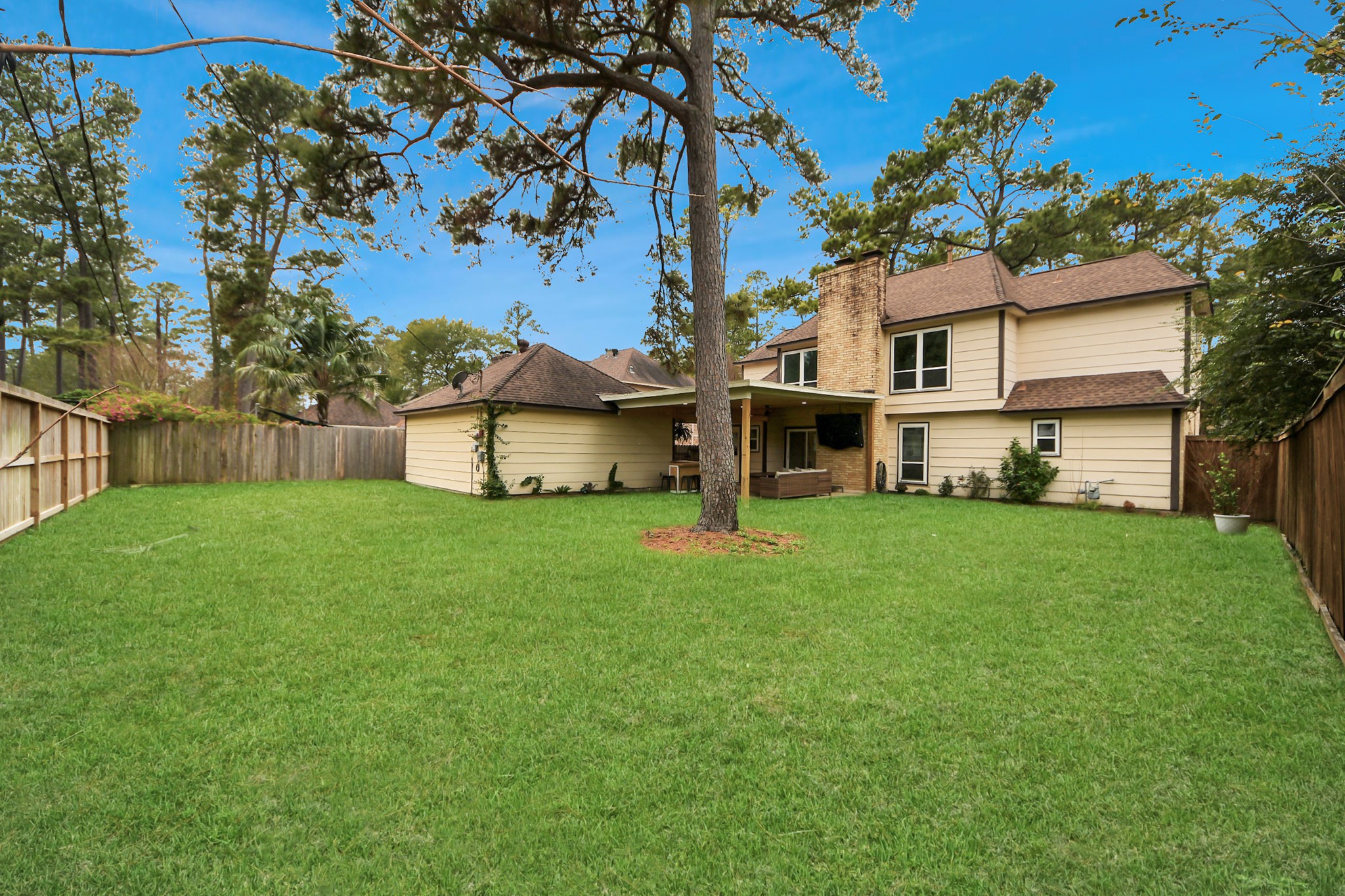 5511 Lacreek Lane Spring, TX 77379 - Photo 38 of 39 a view of a white house in front of a big yard with large trees