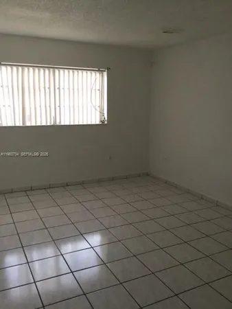 a bathroom with a toilet bathtub and window