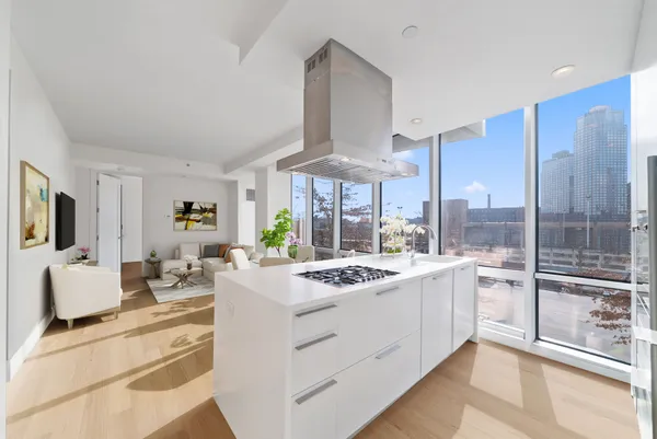 a kitchen with a sink stove and white cabinets