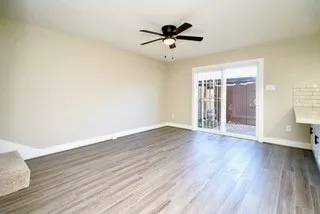 a large white kitchen with kitchen island a sink stainless steel appliances and cabinets