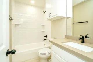 an empty room with a window and a ceiling fan