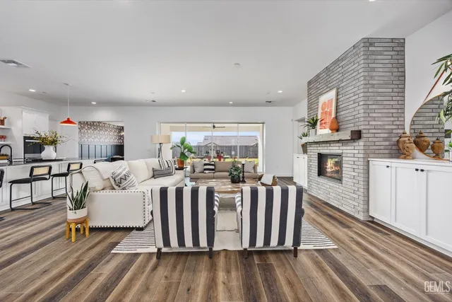 a living room with furniture fireplace and flat screen tv
