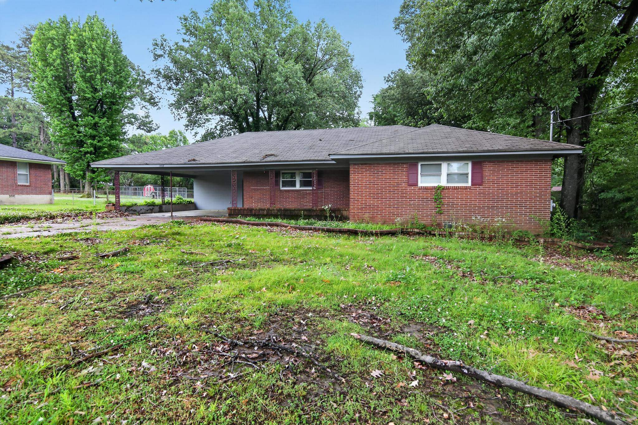 1403 Old Hickory Road Memphis, TN 38116 - Photo 1 of 31 Brick ranch-style residence featuring a covered carport, multi-pane windows, and a shingle roof