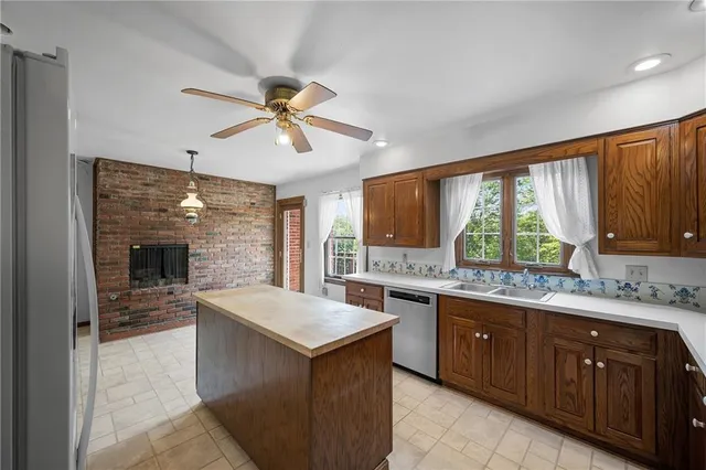 a kitchen with a stove a sink a refrigerator and a microwave