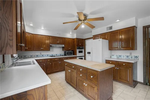 a view of a hallway with white walls and a window