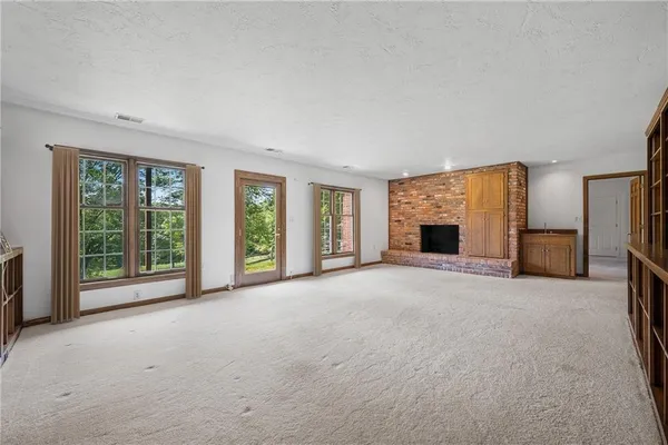 a aerial view of a house with swimming pool next to a yard