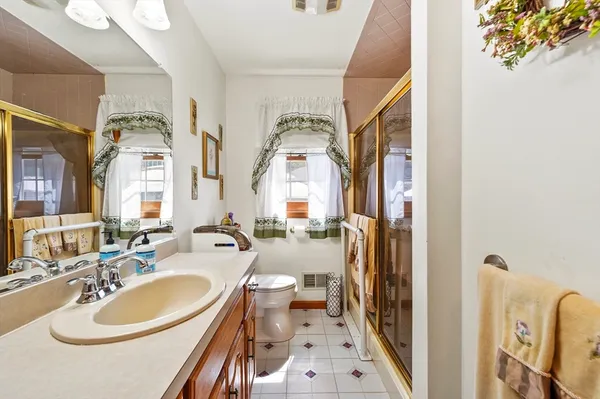 a en suite bathroom with a sink double vanity and a mirror