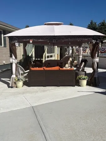 a front view of a house with sitting area and garage