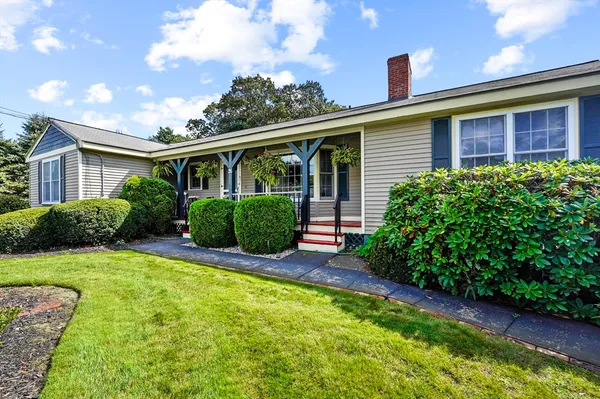 a view of a house with a yard and plants