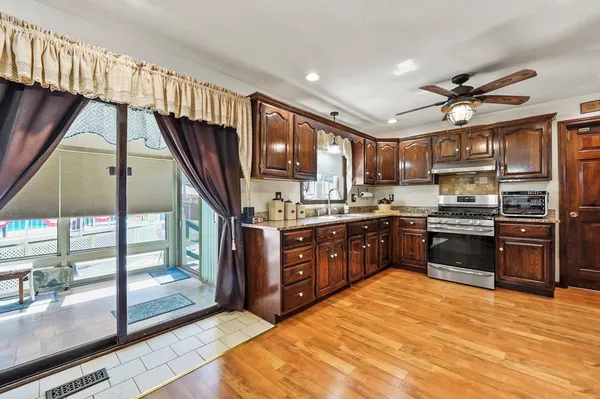 a kitchen with stainless steel appliances kitchen island granite countertop a stove top oven a sink and dishwasher