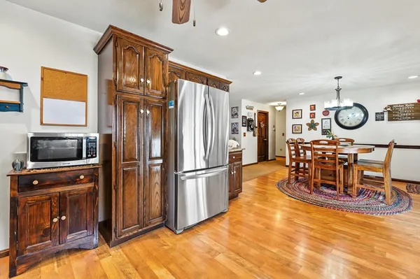 a kitchen with stainless steel appliances granite countertop a refrigerator and a stove top oven