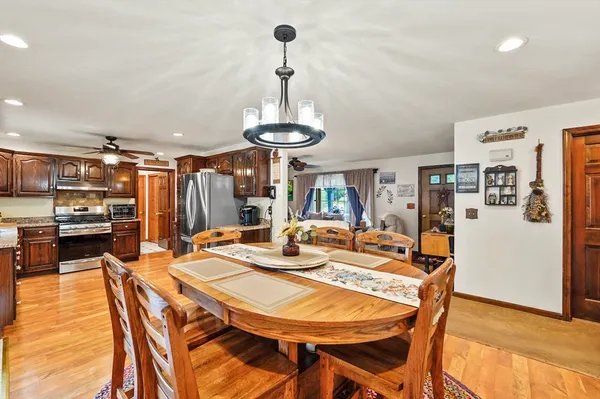a view of a dining room with furniture and wooden floor