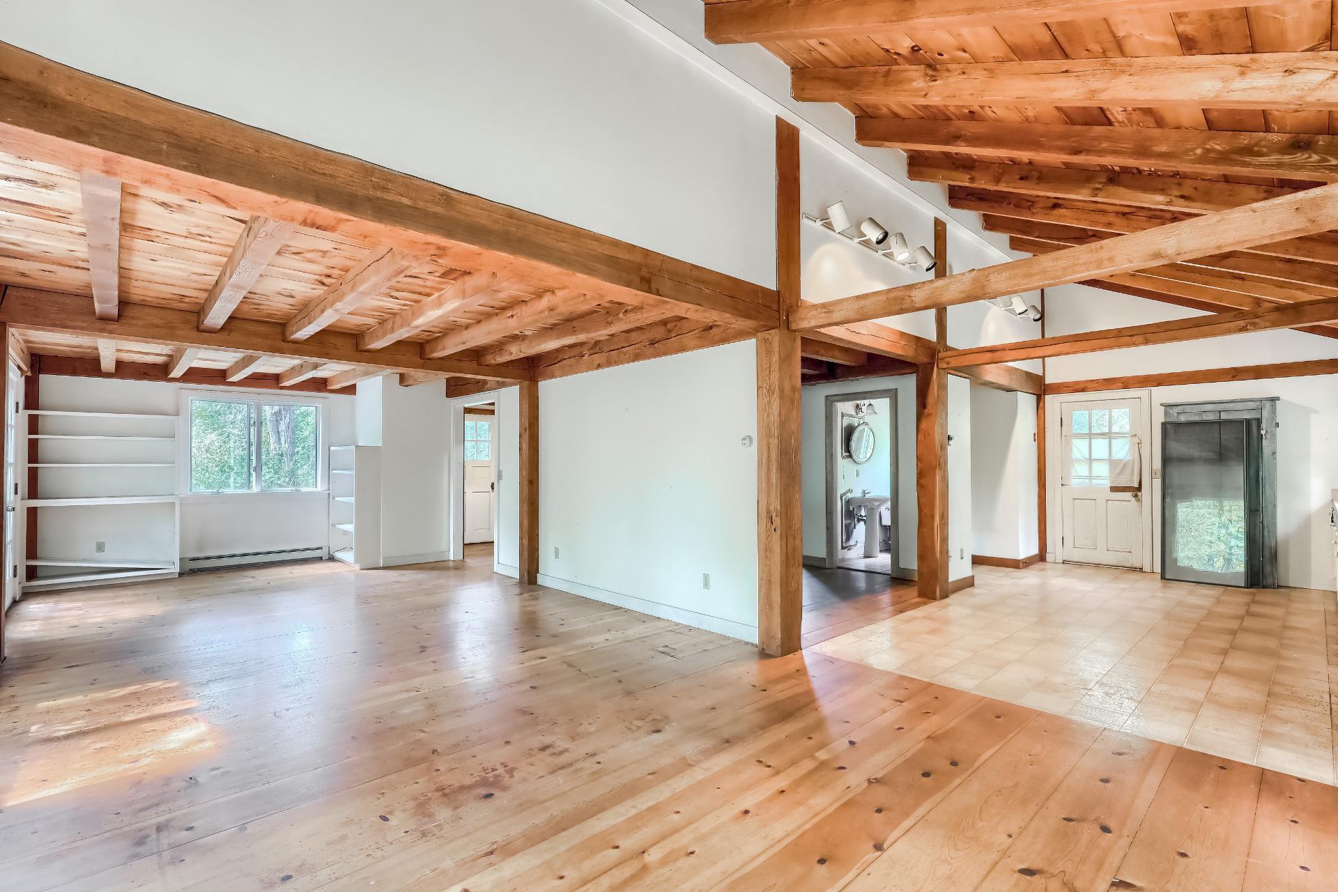 a view of a room with wooden floor