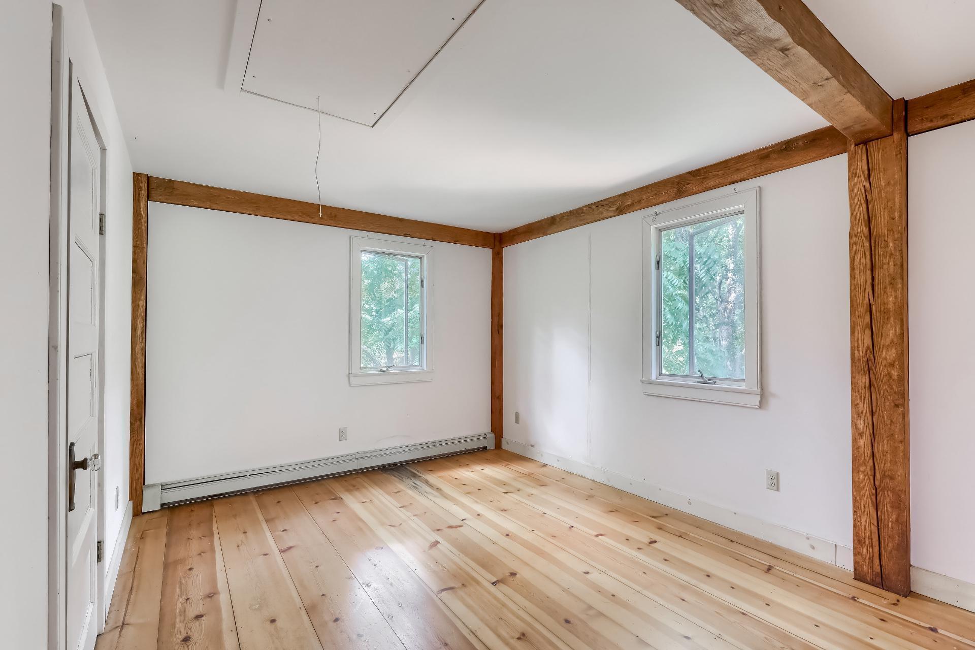 309 Great Fields Road Brewster, MA 02631 - Photo 12 of 23 an empty room with wooden floor and windows