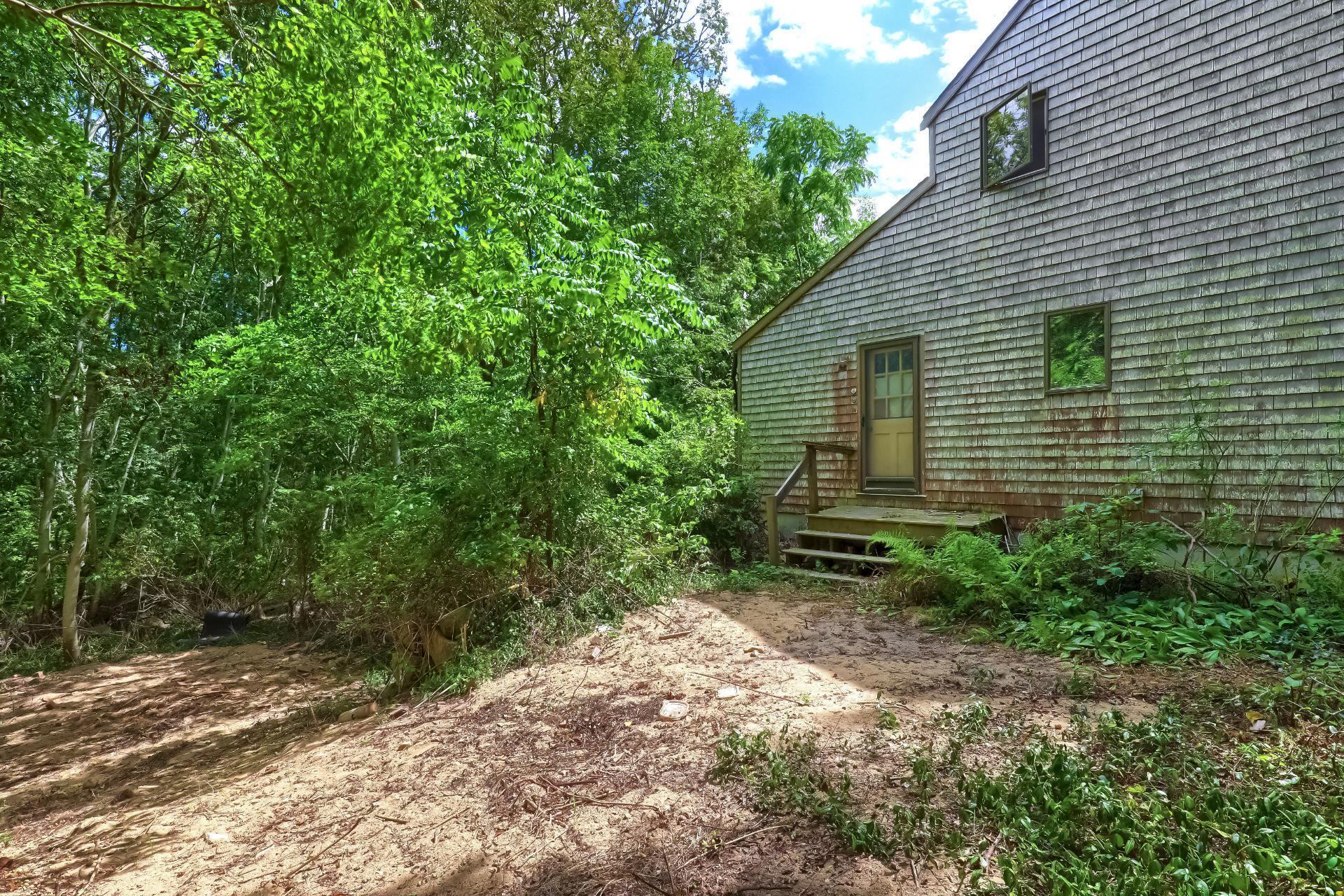 309 Great Fields Road Brewster, MA 02631 - Photo 20 of 23 a backyard of a house with lots of green space
