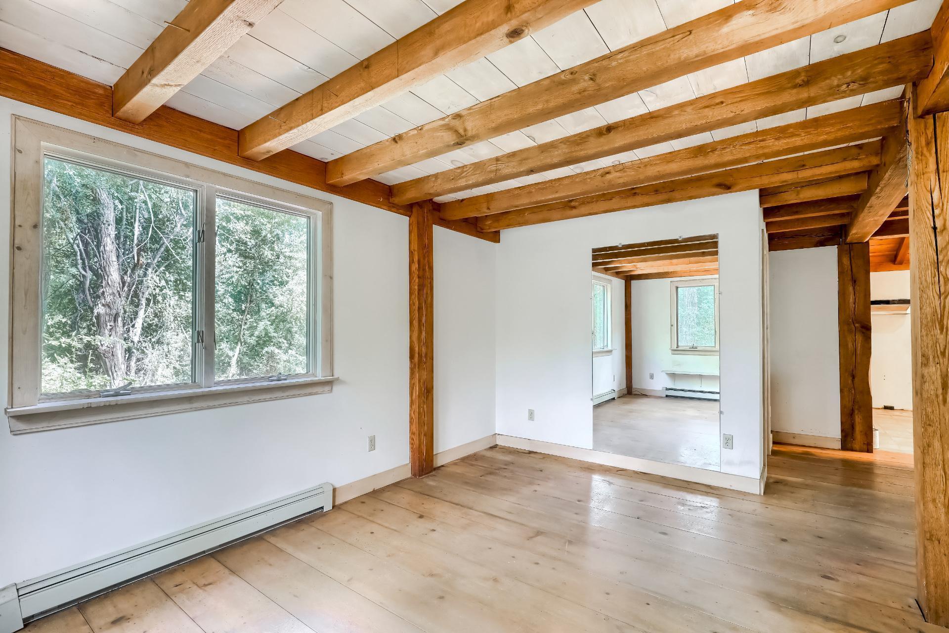 309 Great Fields Road Brewster, MA 02631 - Photo 2 of 23 an empty room with wooden floor and windows