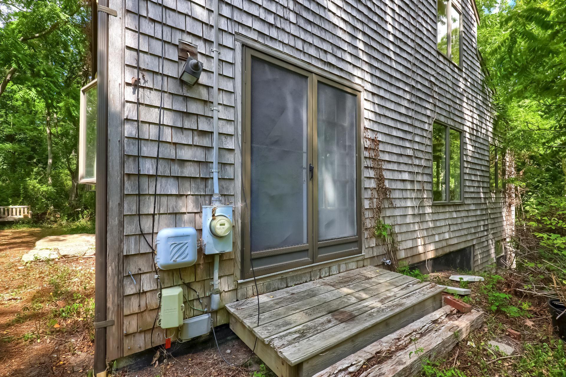 309 Great Fields Road Brewster, MA 02631 - Photo 21 of 23 a wooden door in front of a house