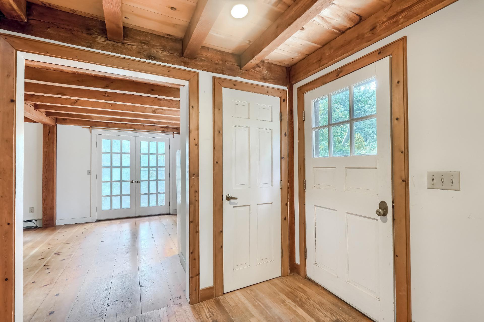 309 Great Fields Road Brewster, MA 02631 - Photo 3 of 23 a view of an empty room with wooden floor and a window