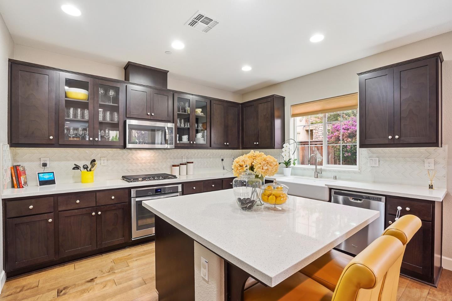 1521 Middle Lane Hayward, CA 94545 - Photo 14 of 34 a kitchen with a stove a refrigerator and a dining table with wooden floor