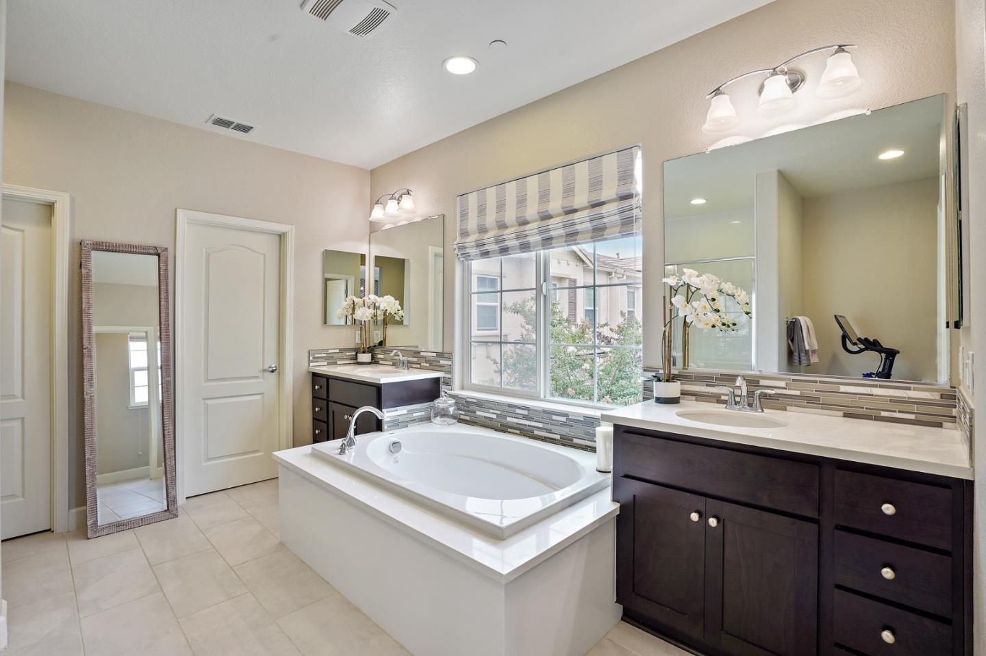 1521 Middle Lane Hayward, CA 94545 - Photo 27 of 34 a bathroom with a sink double vanity granite tub shower and a mirror